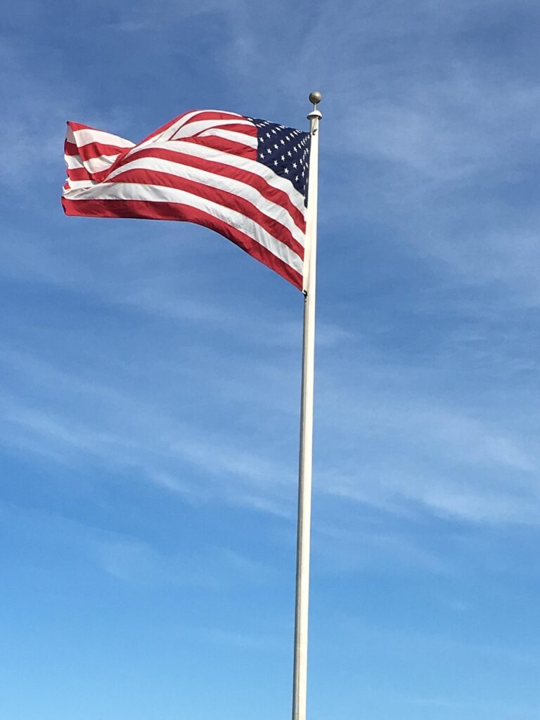 The American Flag on top of a flag pole